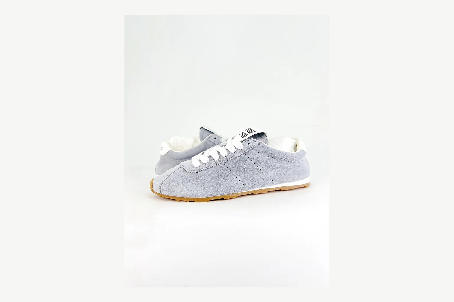 Grey Miu Miu low top on a considered premium-neutral shortlist