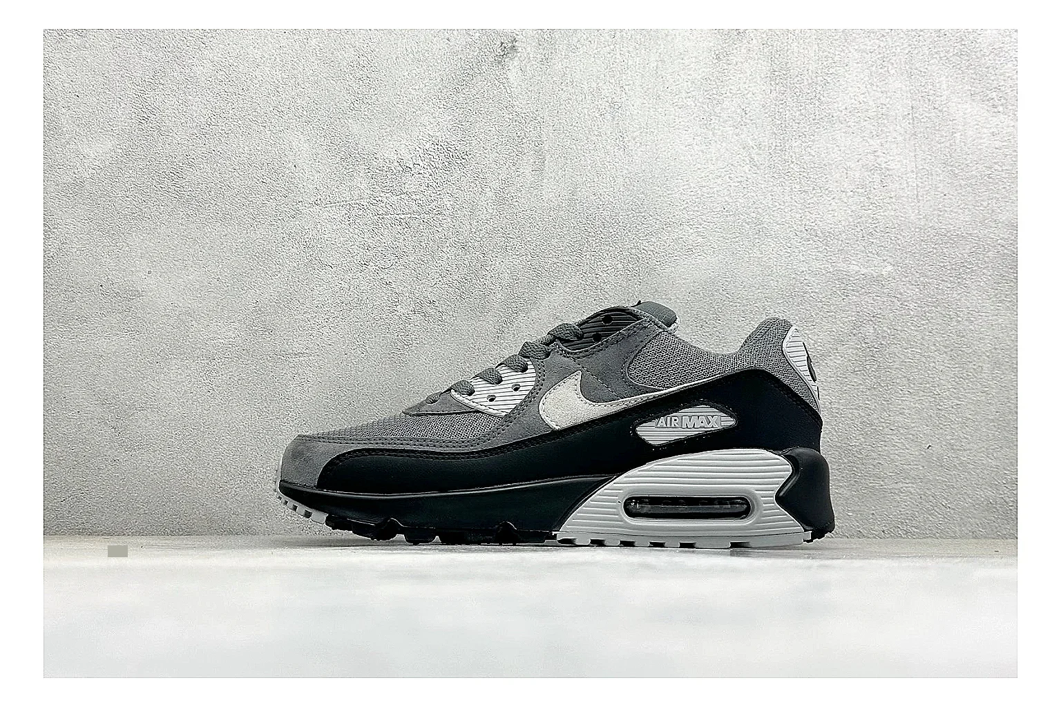 Nike Air Max 90 Grey Black budget find photo showing grey and black layered upper, visible Air window, classic Air Max 90 panels, and sturdy retro sole