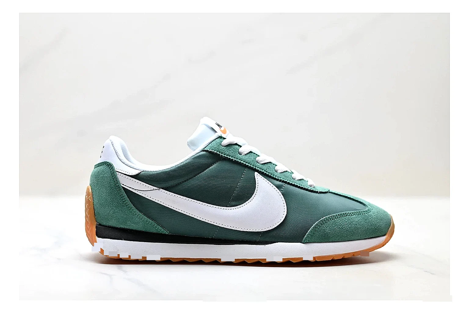 Nike Cortez Green White budget find photo showing green white leather low-top upper, slim retro runner profile, Swoosh detail, and classic Cortez sole