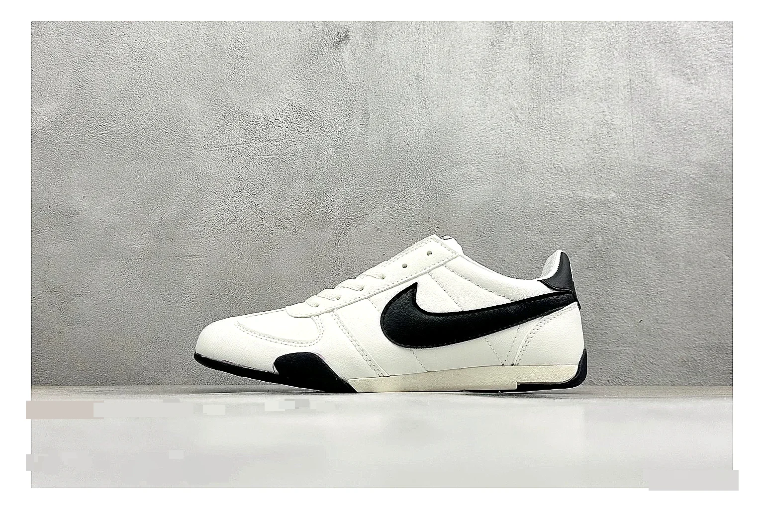 Nike Sprint Sister White Black budget find photo showing white retro-runner upper, black Swoosh contrast, slim low-top profile, and light casual sole