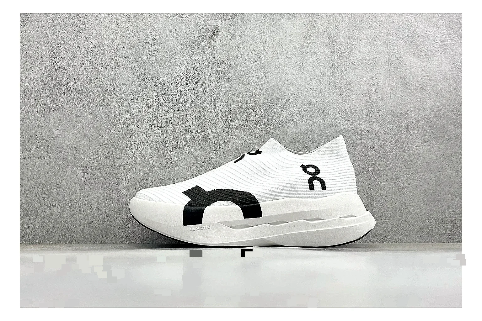 On Cloudboom White Black budget find photo showing white performance mesh, black contrast details, slim racing profile, and segmented CloudTec sole