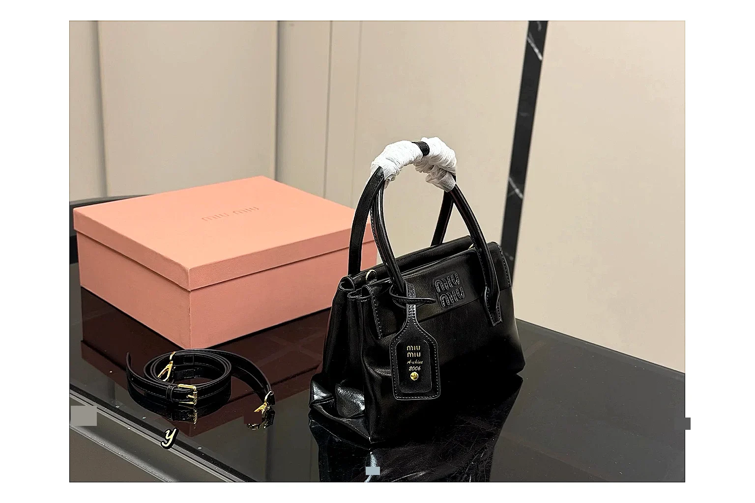 Prada Mini Top Handle Black budget find photo showing black leather mini bag body, structured top handle, compact luxury shape, and clean hardware details