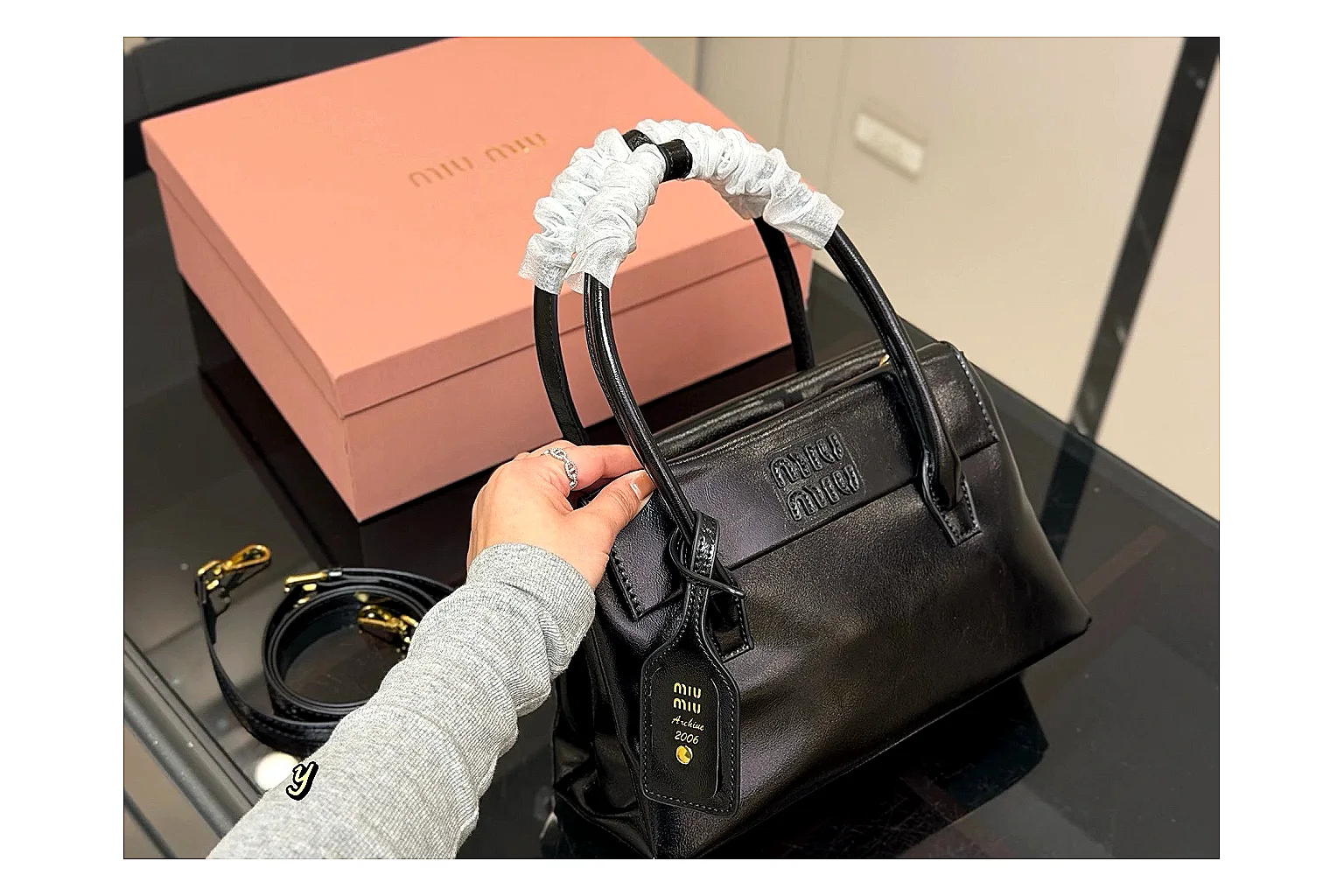 Prada Mini Top Handle Black budget find photo showing black leather mini bag body, structured top handle, compact luxury shape, and clean hardware details thumbnail 2