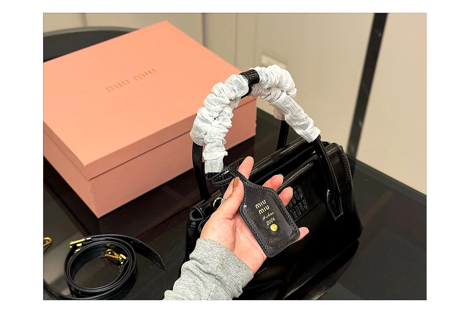 Prada Mini Top Handle Black budget find photo showing black leather mini bag body, structured top handle, compact luxury shape, and clean hardware details thumbnail 3
