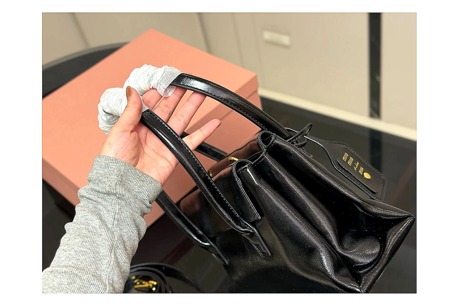 Prada Mini Top Handle Black budget find photo showing black leather mini bag body, structured top handle, compact luxury shape, and clean hardware details thumbnail 6